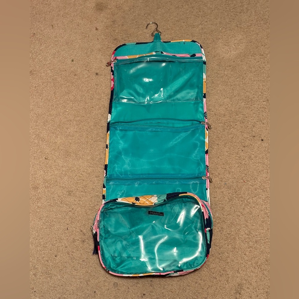 Lightly used Modella roll-up makeup travel/hanging device with 4 compartments